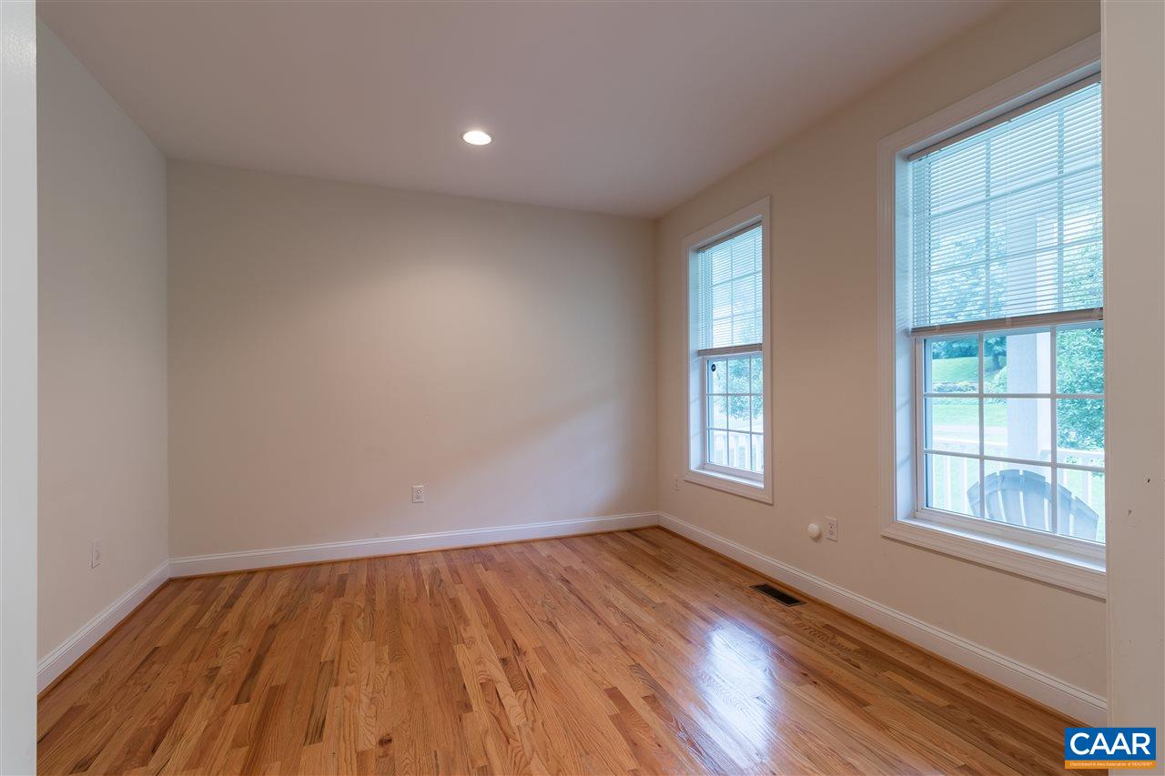 282 Lake Drive, Unit 2 Ruckersville, VA 22968 - Photo 10 of 27 an empty room with wooden floor and windows