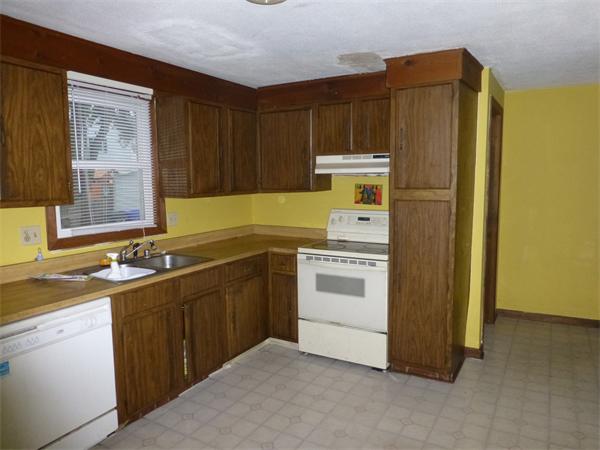 57-59 Howes Street Springfield, MA 01118 - Photo 6 of 14 a kitchen with a sink and a refrigerator