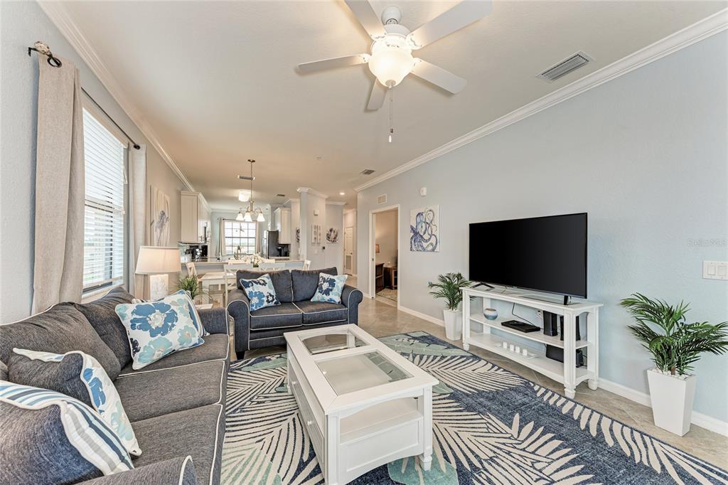 16804 Vardon Terrace, Unit 308 Bradenton, FL 34211 - Photo 11 of 43 a living room with furniture a flat screen tv and a large window