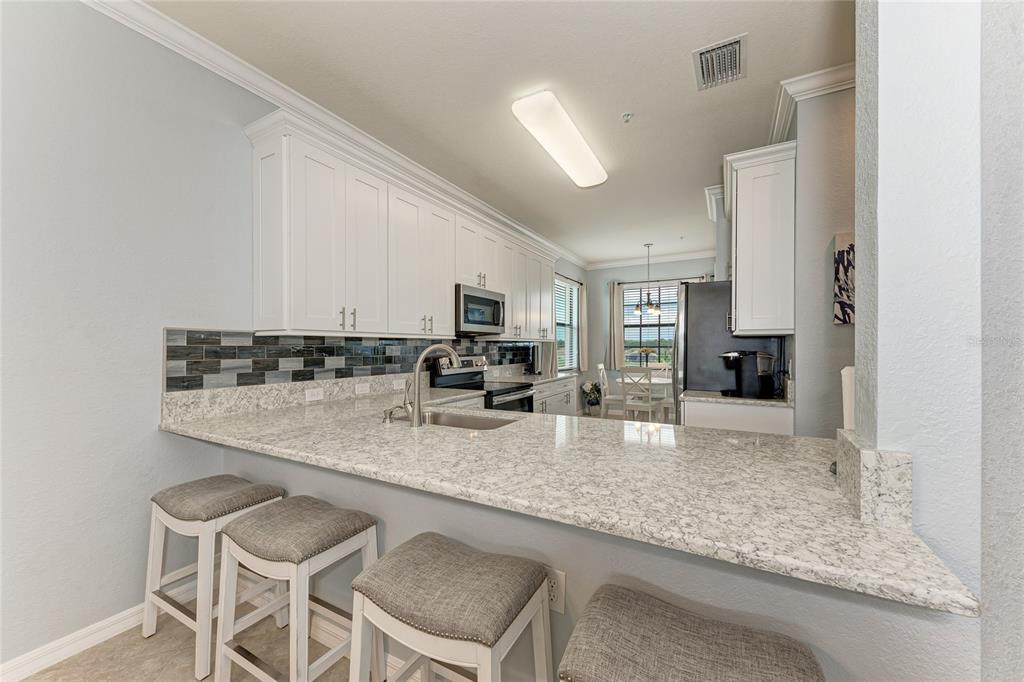 16804 Vardon Terrace, Unit 308 Bradenton, FL 34211 - Photo 13 of 43 a kitchen with sink and center island
