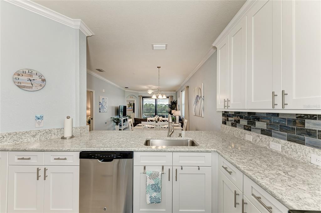 16804 Vardon Terrace, Unit 308 Bradenton, FL 34211 - Photo 15 of 43 a kitchen with sink cabinets and stove