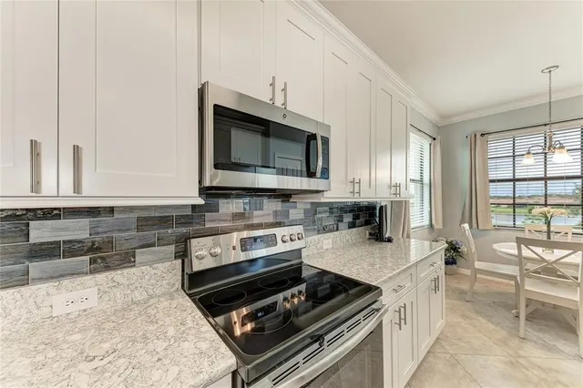 a kitchen with stainless steel appliances a stove sink and microwave