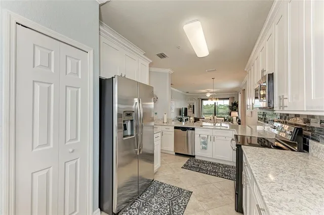 a kitchen with refrigerator and window