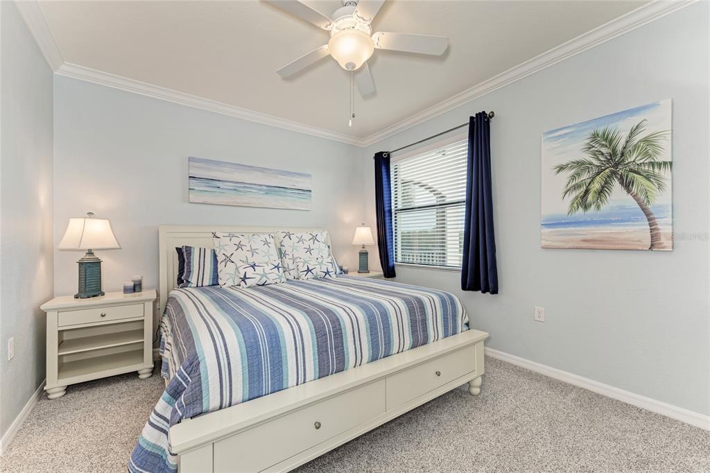 16804 Vardon Terrace, Unit 308 Bradenton, FL 34211 - Photo 20 of 43 a bedroom with a bed and a chandelier