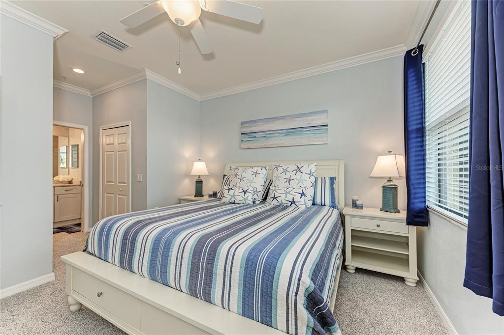16804 Vardon Terrace, Unit 308 Bradenton, FL 34211 - Photo 21 of 43 a bedroom with a bed and a chandelier