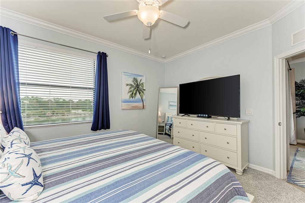 16804 Vardon Terrace, Unit 308 Bradenton, FL 34211 - Photo 22 of 43 a bedroom with a bed and a flat screen tv