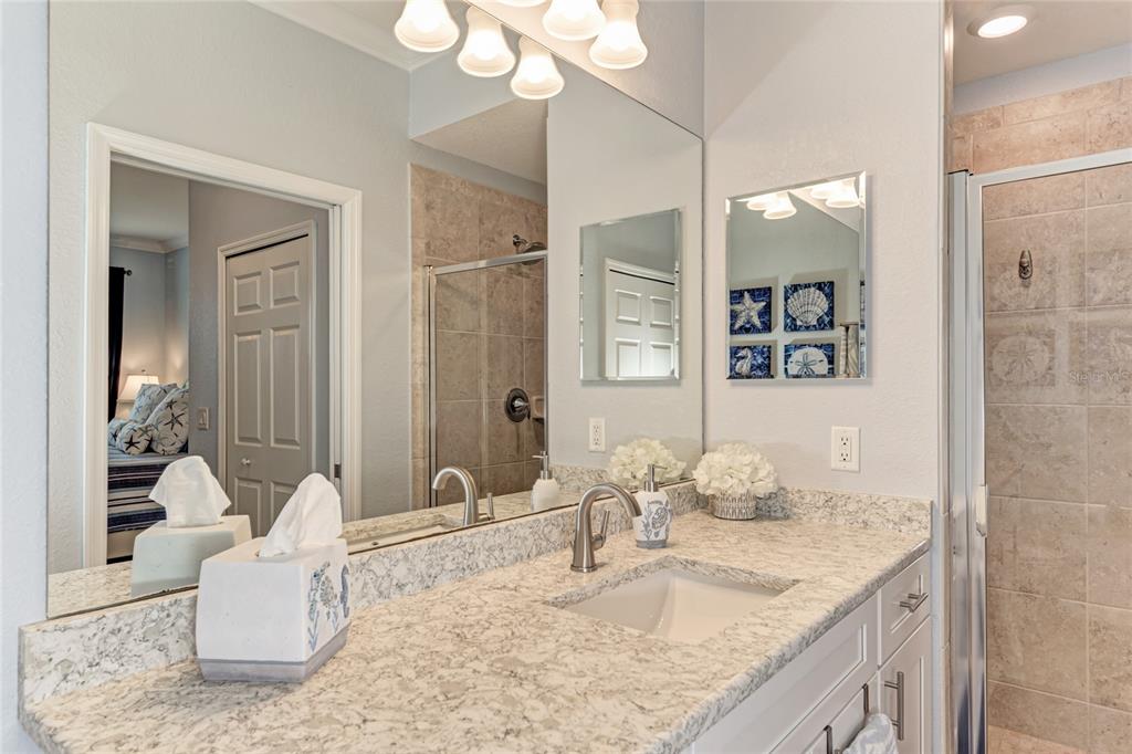 16804 Vardon Terrace, Unit 308 Bradenton, FL 34211 - Photo 23 of 43 a bathroom with a granite countertop sink and a mirror