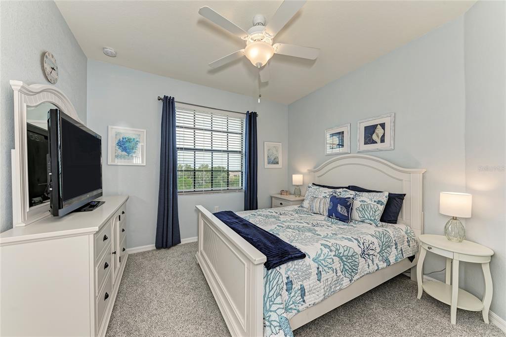 16804 Vardon Terrace, Unit 308 Bradenton, FL 34211 - Photo 27 of 43 a bedroom with a bed and a flat screen tv