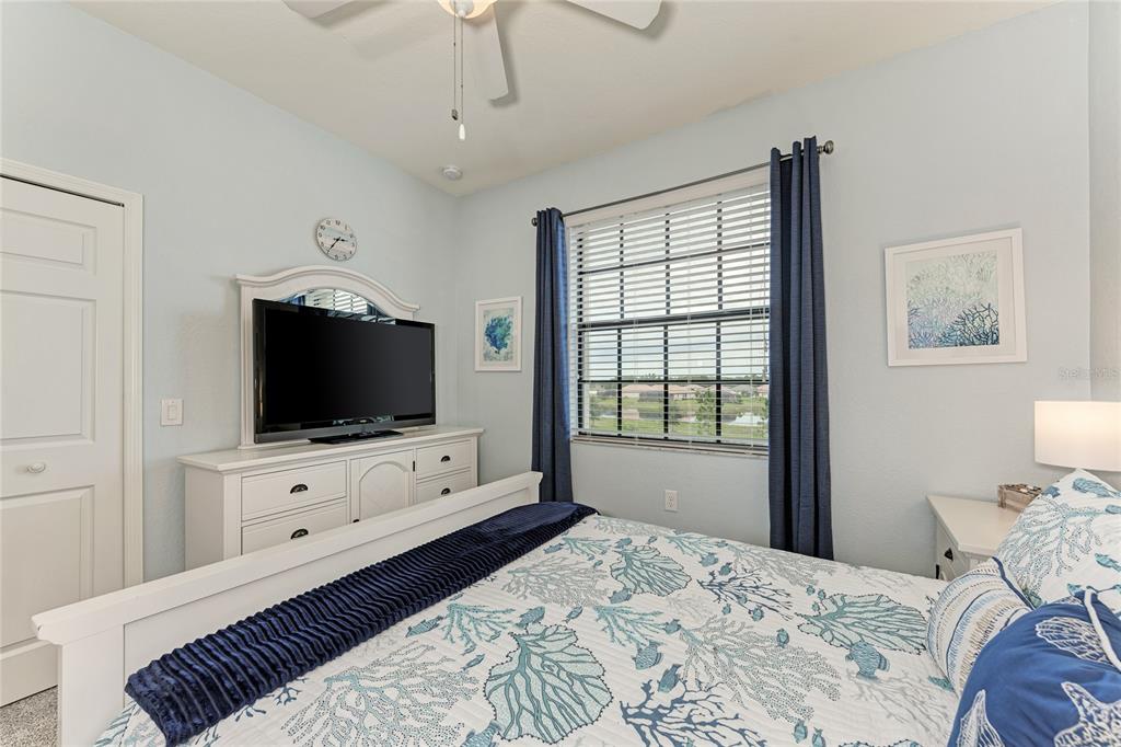 16804 Vardon Terrace, Unit 308 Bradenton, FL 34211 - Photo 28 of 43 a bedroom with a bed and a flat screen tv