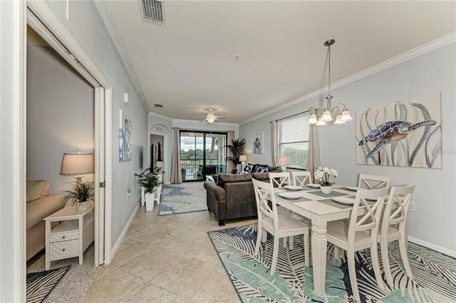 a view of a dining room with furniture and a chandelier