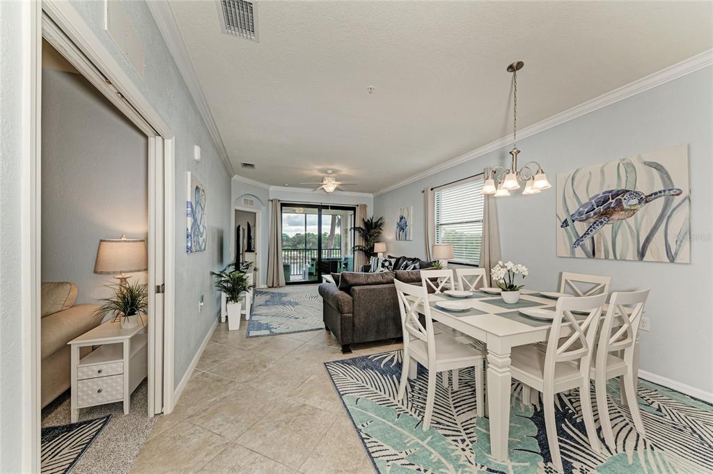 16804 Vardon Terrace, Unit 308 Bradenton, FL 34211 - Photo 6 of 43 a view of a dining room with furniture and a chandelier