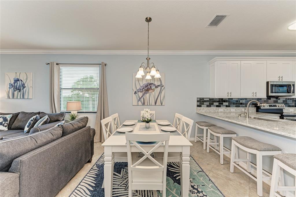 16804 Vardon Terrace, Unit 308 Bradenton, FL 34211 - Photo 7 of 43 a dining room with furniture a chandelier and window