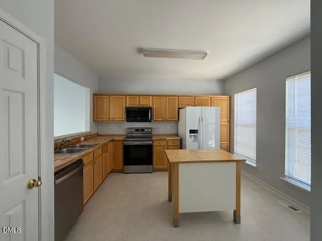 a kitchen with a stove and a refrigerator