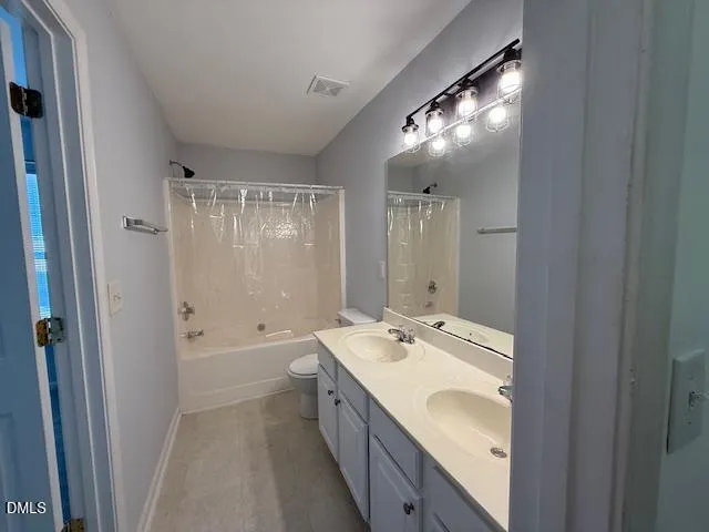 a bathroom with a double vanity sink and mirror with shower
