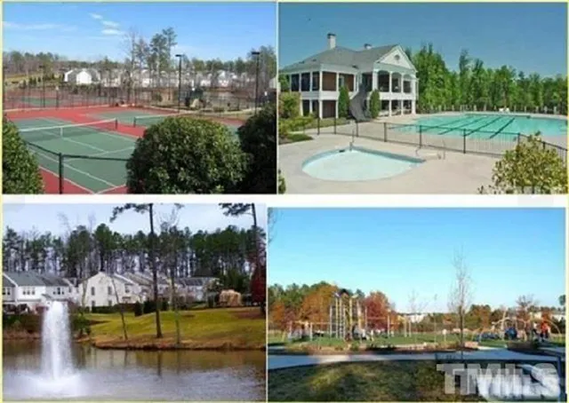 an aerial view of a house with a yard swimming pool and outdoor seating