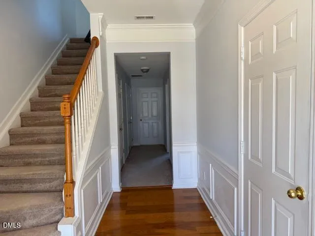 a view of a hallway with wooden floor and entryway