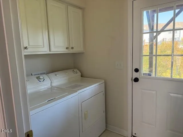 a utility room with dryer and window