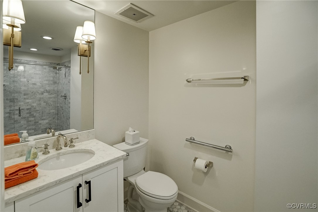 413 Stuart Circle, Unit 4C Richmond, VA 23220 - Photo 10 of 27 a bathroom with a sink a toilet and shower