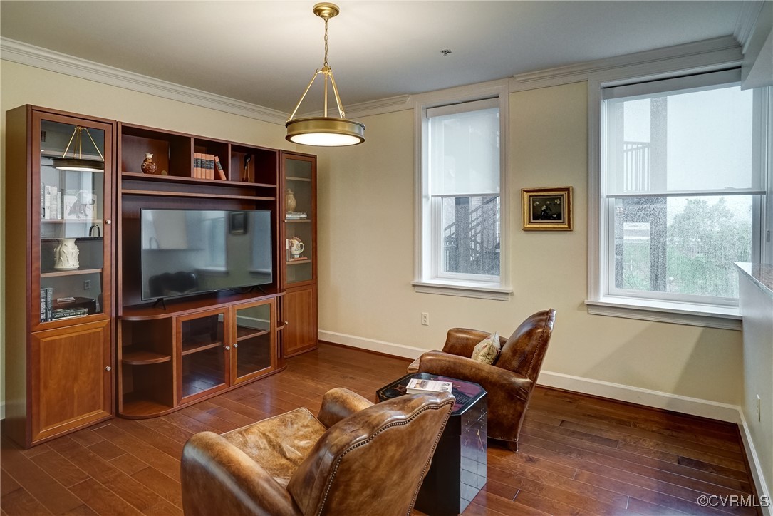 413 Stuart Circle, Unit 4C Richmond, VA 23220 - Photo 4 of 27 a living room with furniture a flat screen tv and wooden floor