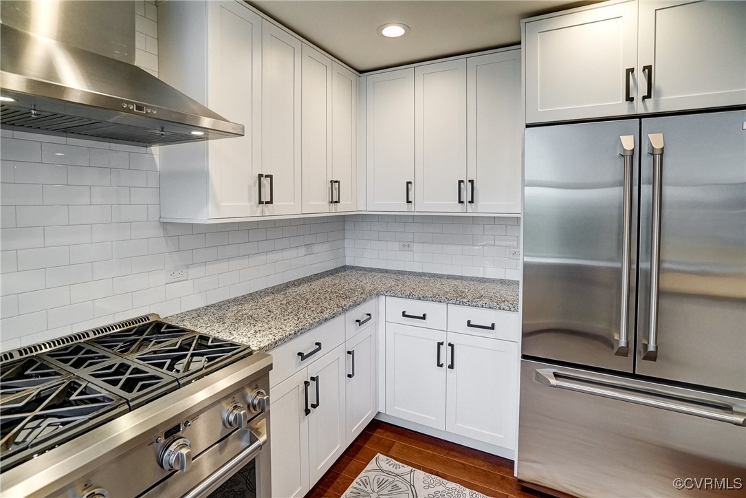 413 Stuart Circle, Unit 4C Richmond, VA 23220 - Photo 8 of 27 a kitchen with granite countertop white cabinets and stainless steel appliances