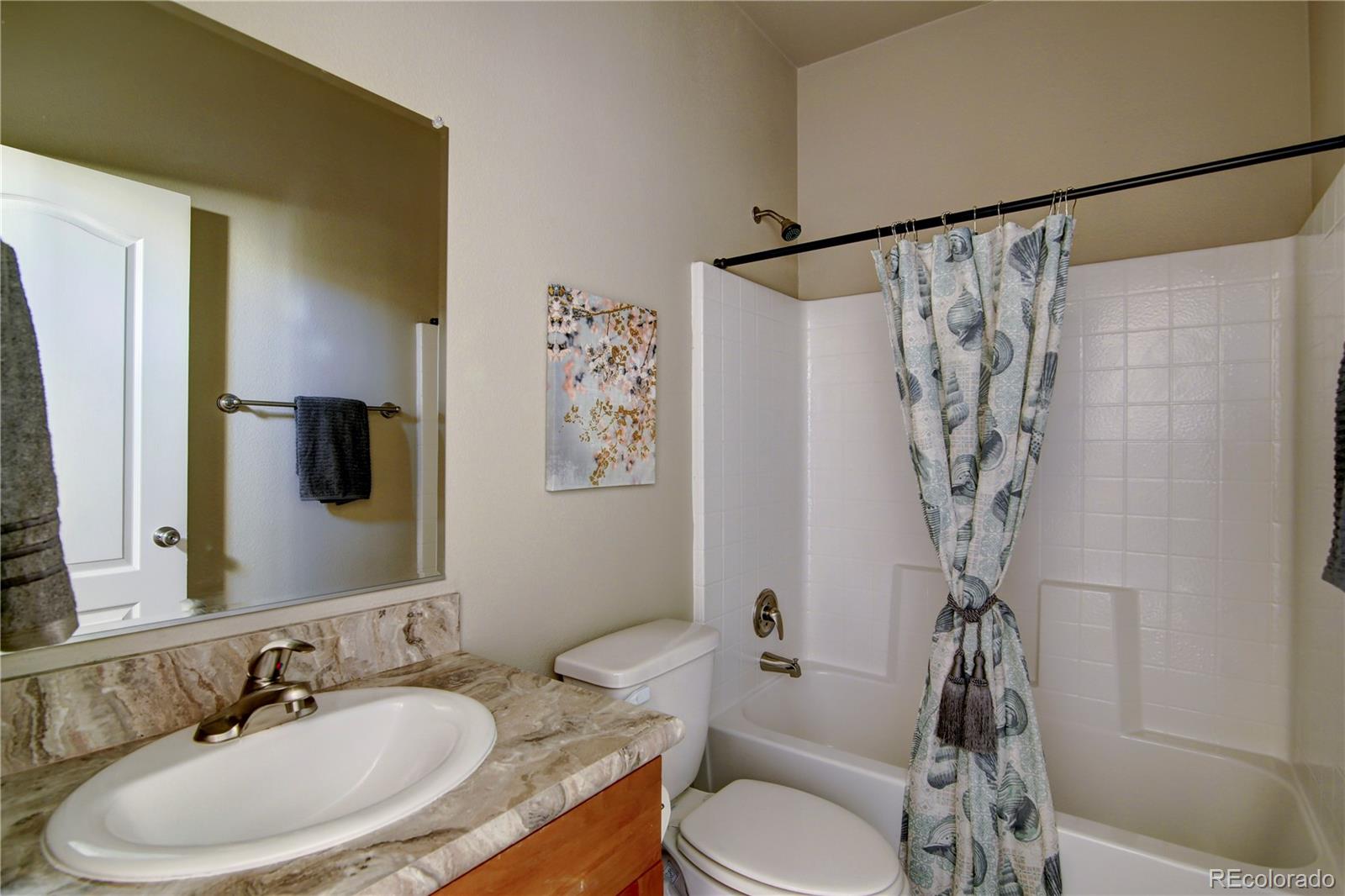 125 12th Street Fairplay, CO 80440 - Photo 14 of 17 a bathroom with a granite countertop sink a toilet and shower