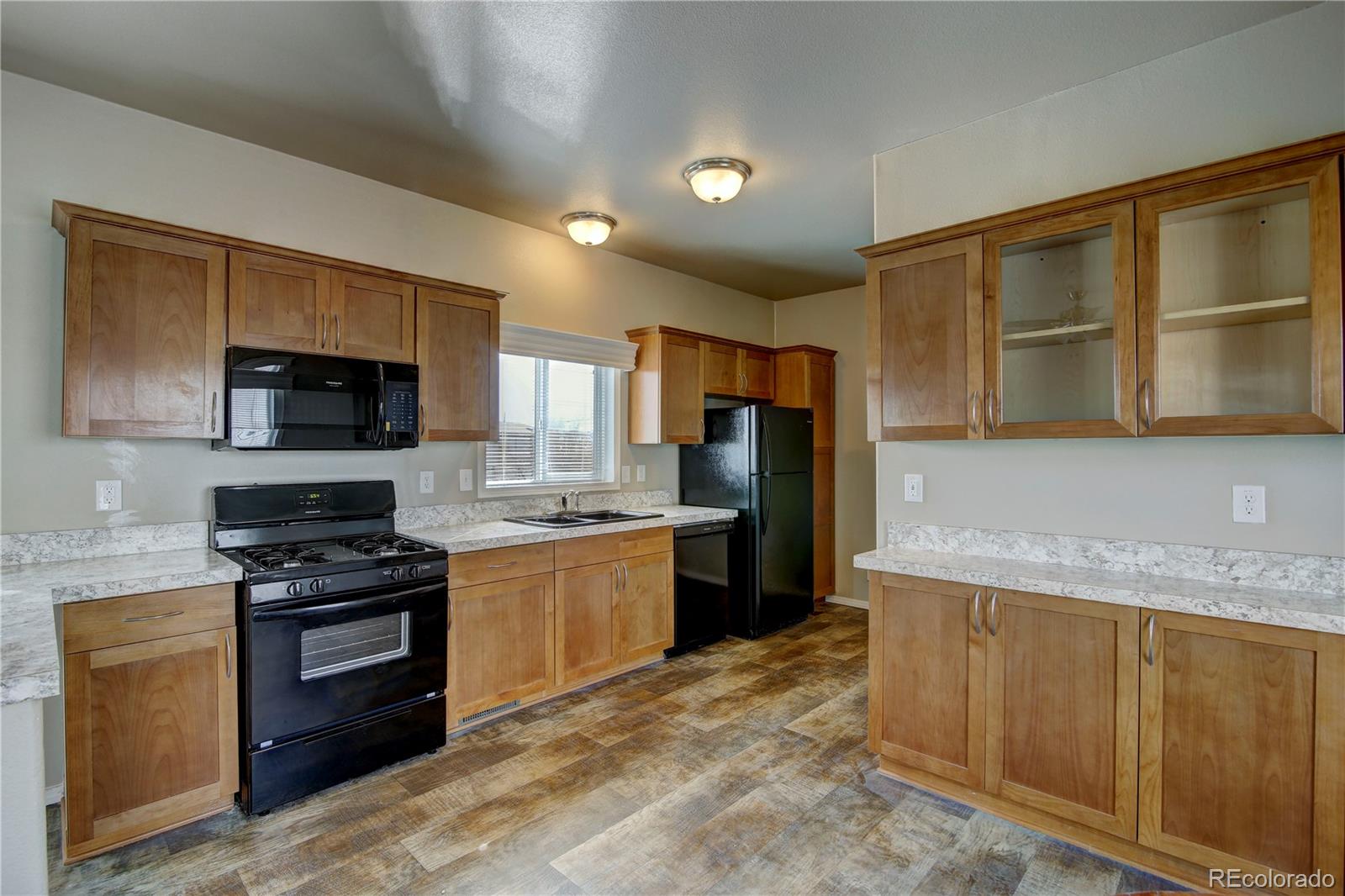 125 12th Street Fairplay, CO 80440 - Photo 4 of 17 a kitchen with stainless steel appliances granite countertop a stove top oven a sink dishwasher a refrigerator and a microwave oven with large the oven