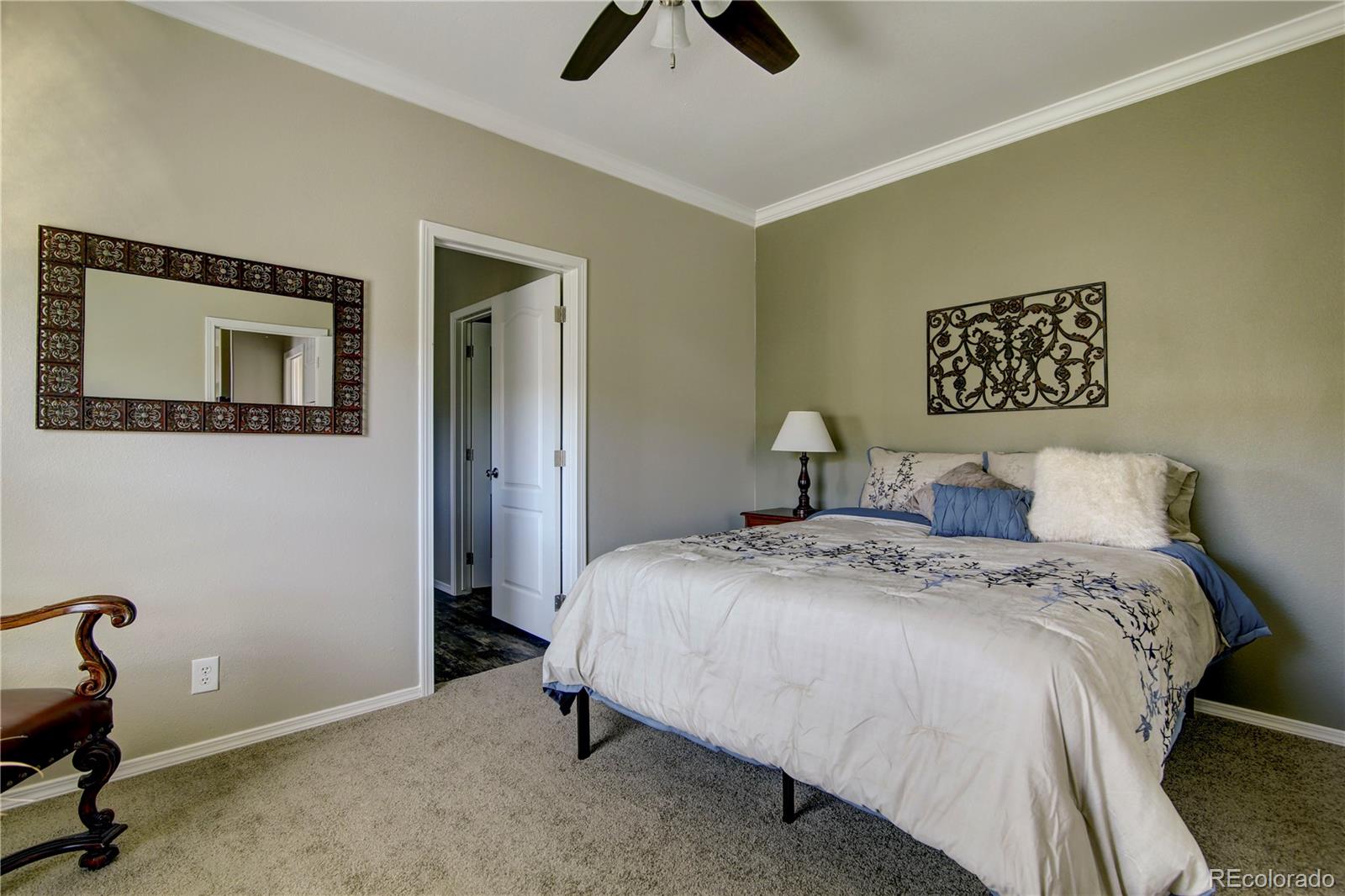 125 12th Street Fairplay, CO 80440 - Photo 9 of 17 a bedroom with a bed and a chandelier