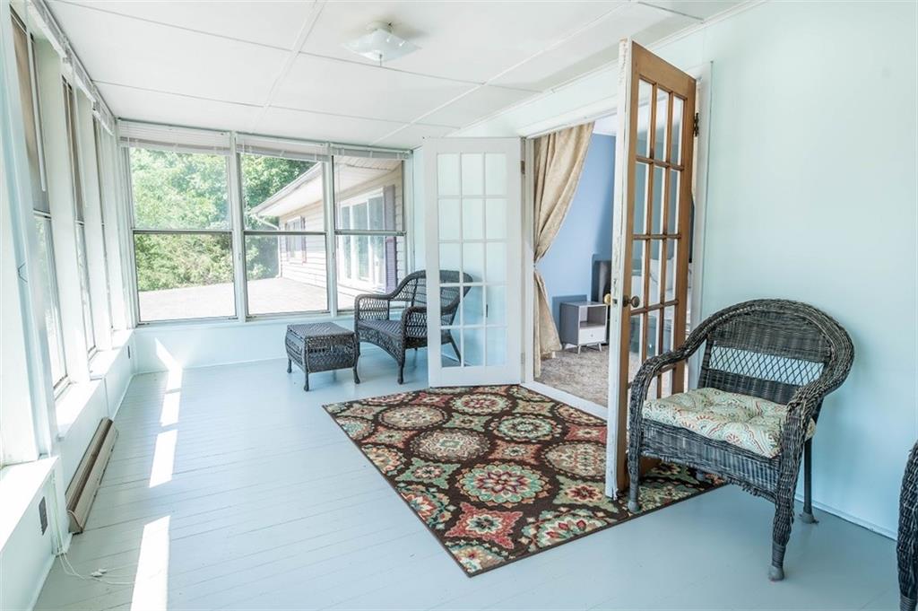 47 McMillen Road Home, PA 15747 - Photo 17 of 19 a living room with furniture and a floor to ceiling window