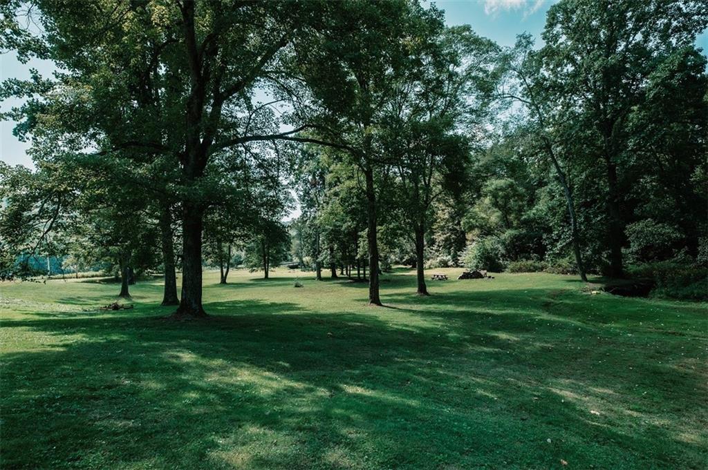 47 McMillen Road Home, PA 15747 - Photo 4 of 19 a view of grassy field with benches and trees all around