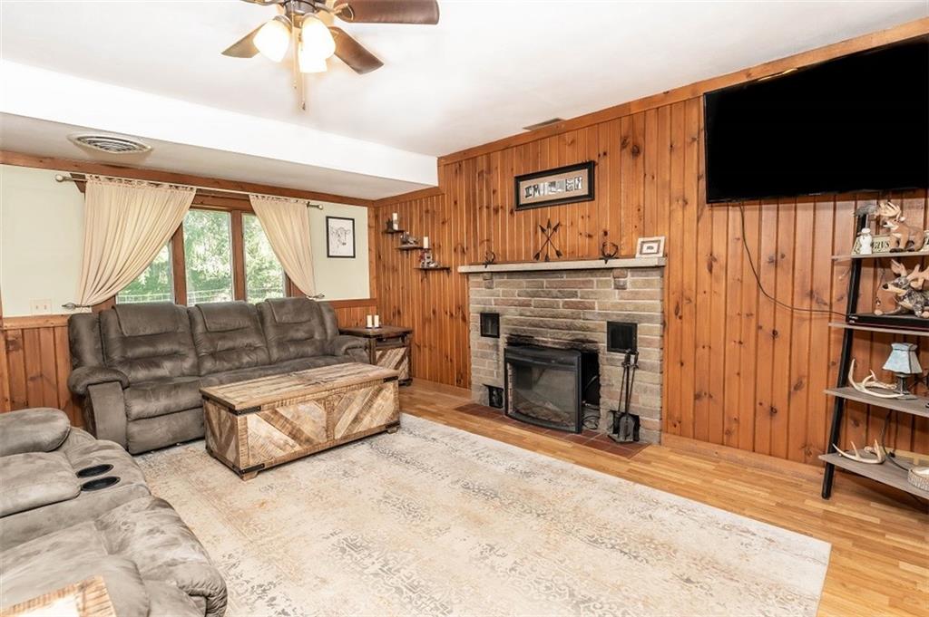 47 McMillen Road Home, PA 15747 - Photo 7 of 19 a living room with furniture a flat screen tv and a fireplace