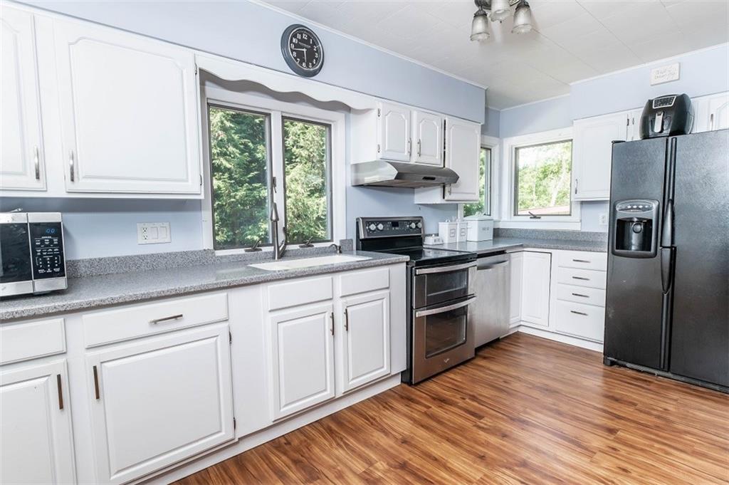 47 McMillen Road Home, PA 15747 - Photo 9 of 19 a kitchen with stainless steel appliances a white cabinets and a window