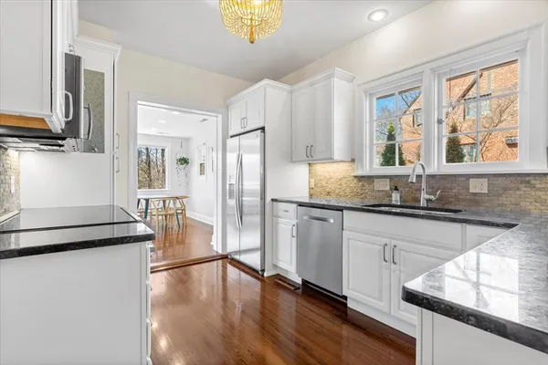 a kitchen with stainless steel appliances granite countertop a stove a sink and a refrigerator