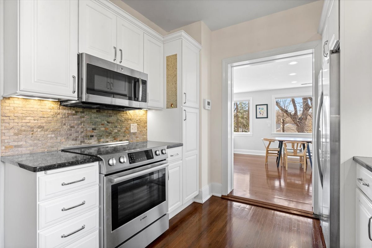 2121 South Illini Road Springfield, IL 62704 - Photo 17 of 43 a kitchen with granite countertop a stove and a microwave