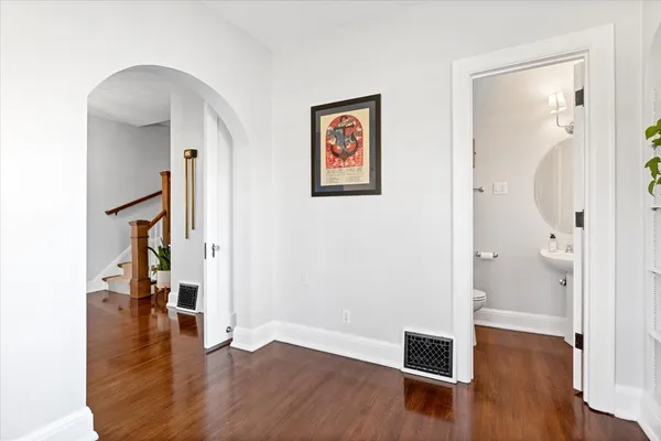 a view of a hallway with wooden floor and entryway