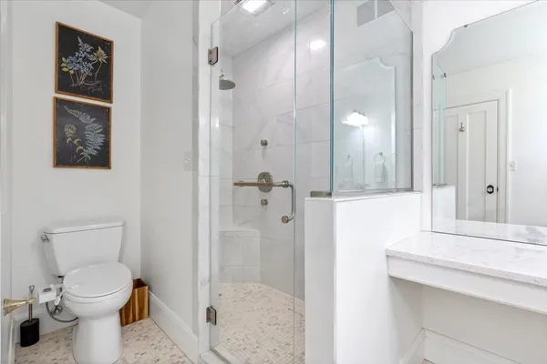 a bathroom with a shower toilet and sink