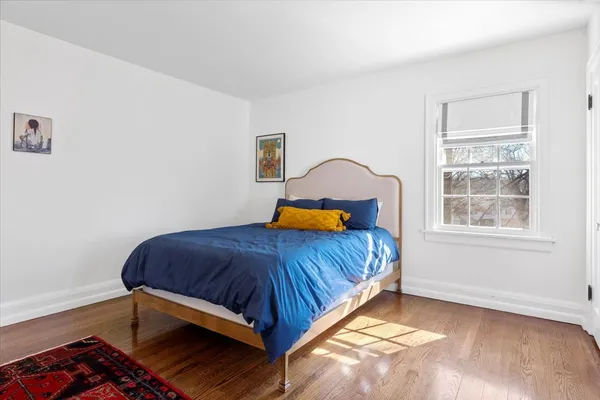 a bedroom with a bed and window