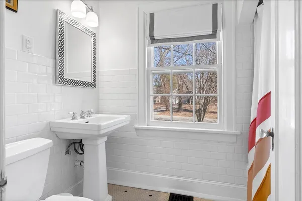 a bathroom with a sink a mirror and a toilet