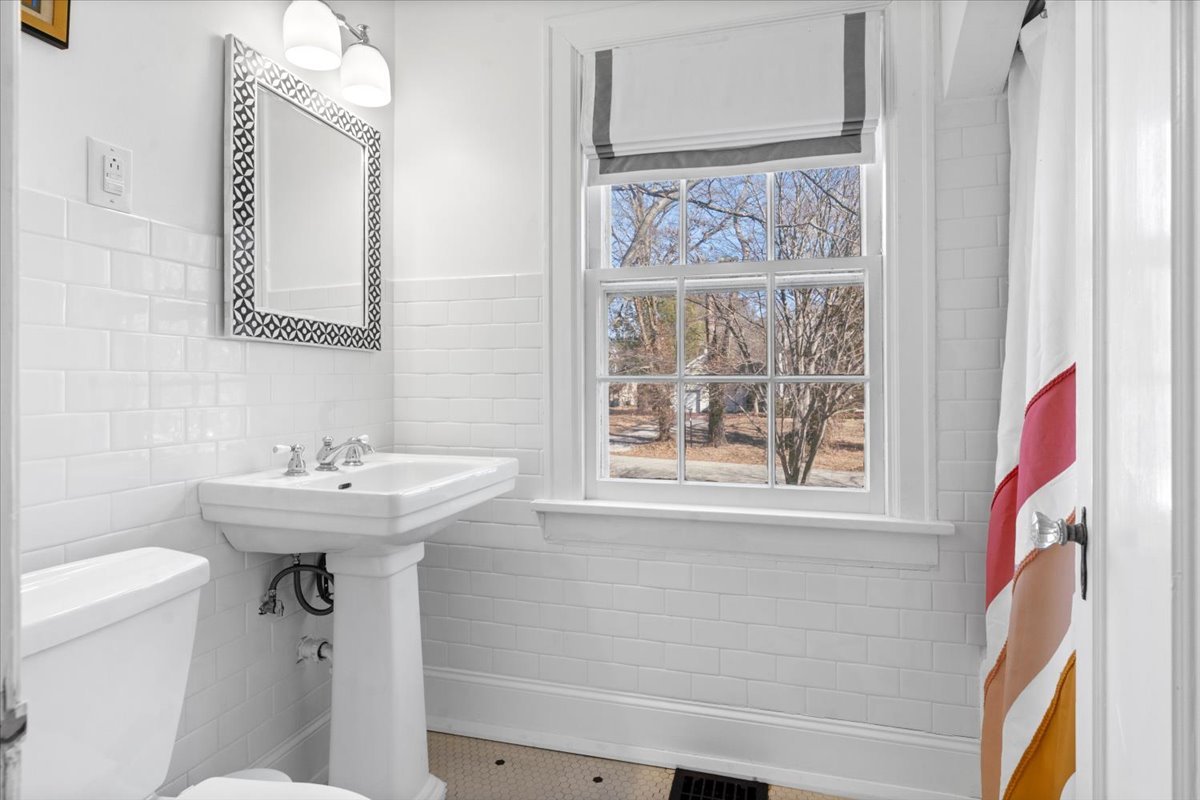 2121 South Illini Road Springfield, IL 62704 - Photo 31 of 43 a bathroom with a sink a mirror and a toilet