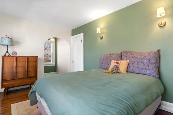 a bedroom with a bed and dresser