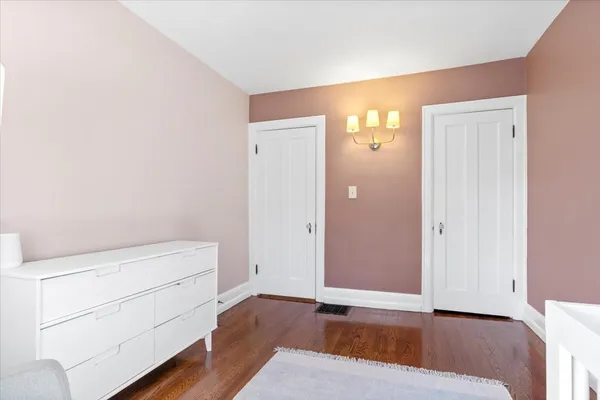 a view of a room with wooden floor and cabinet