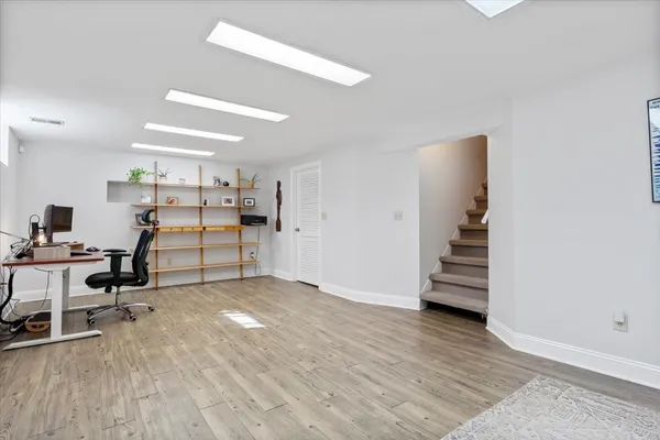 a view of a room with wooden floor and windows