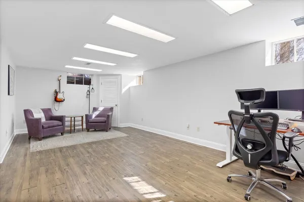 a view of a workspace with furniture and a window