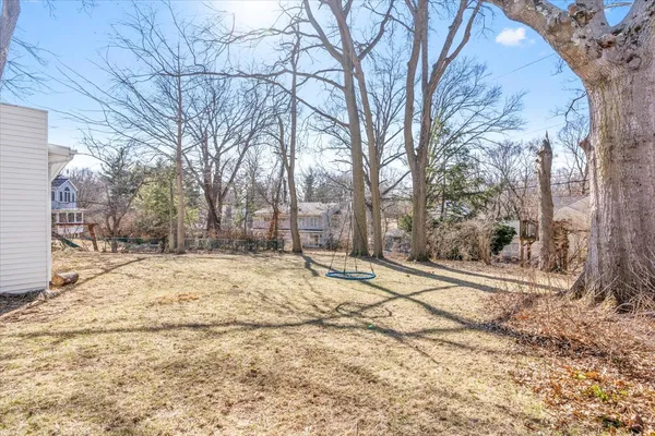 a view of a yard with snow on the road
