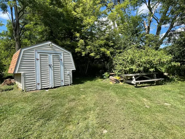 a view of a backyard with a garden and entertaining space