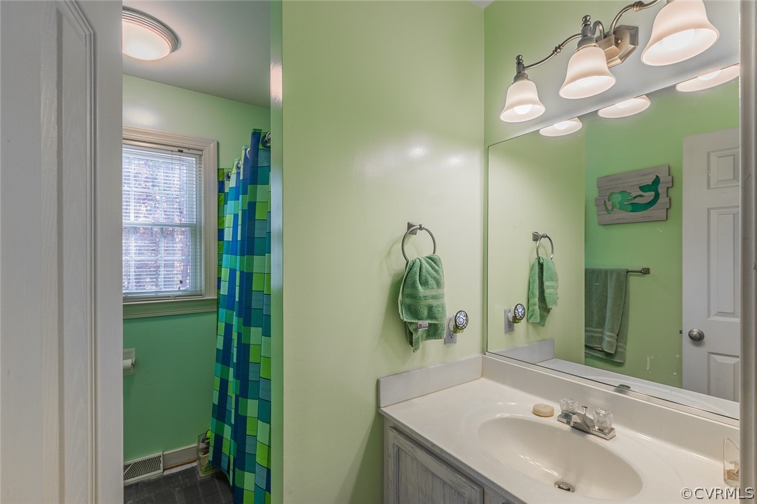826 Jackson Road Bumpass, VA 23024 - Photo 16 of 26 a bathroom with a sink a mirror and a window