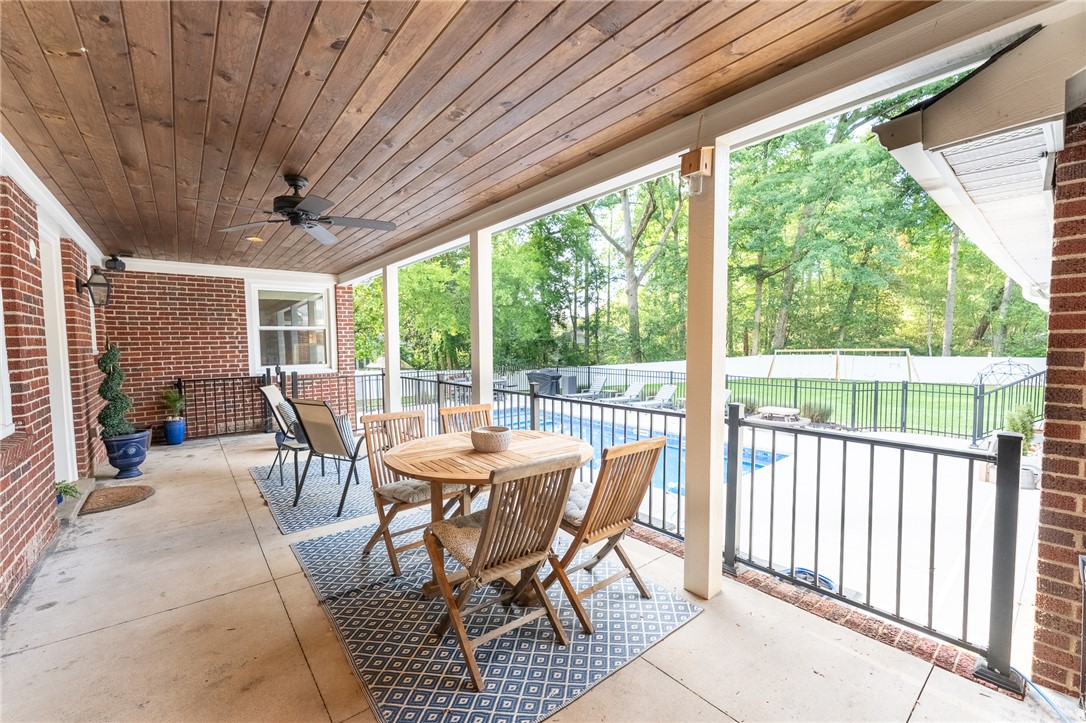 103 Riggs Drive Clemson, SC 29631 - Photo 31 of 50 Enjoy outdoor gatherings on this covered patio, offering serene views of the fenced backyard and pool.