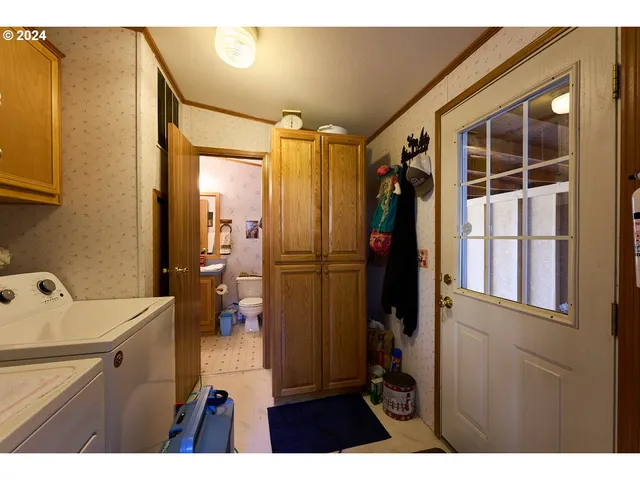 a living room with a baby crib furniture and a window