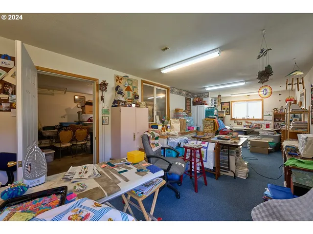 a living room with lots of furniture and painting on the wall