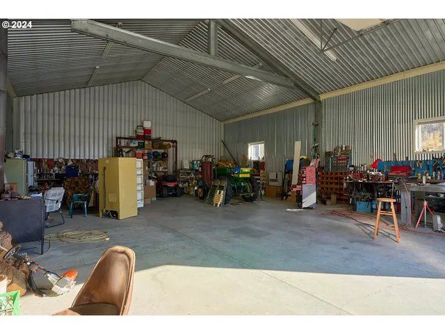 a living room with lots of furniture and equipment