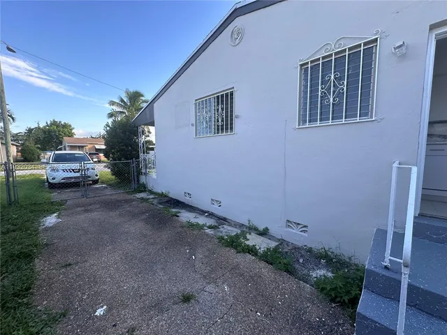 a backyard of a house with outdoor seating